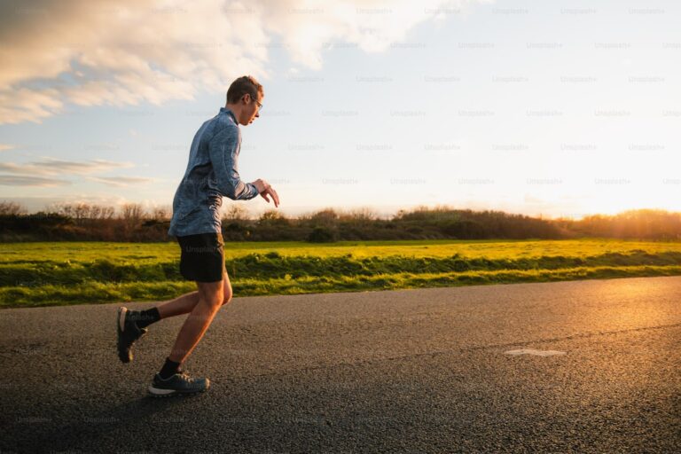 Athlete running outdoors on road during fartlek training